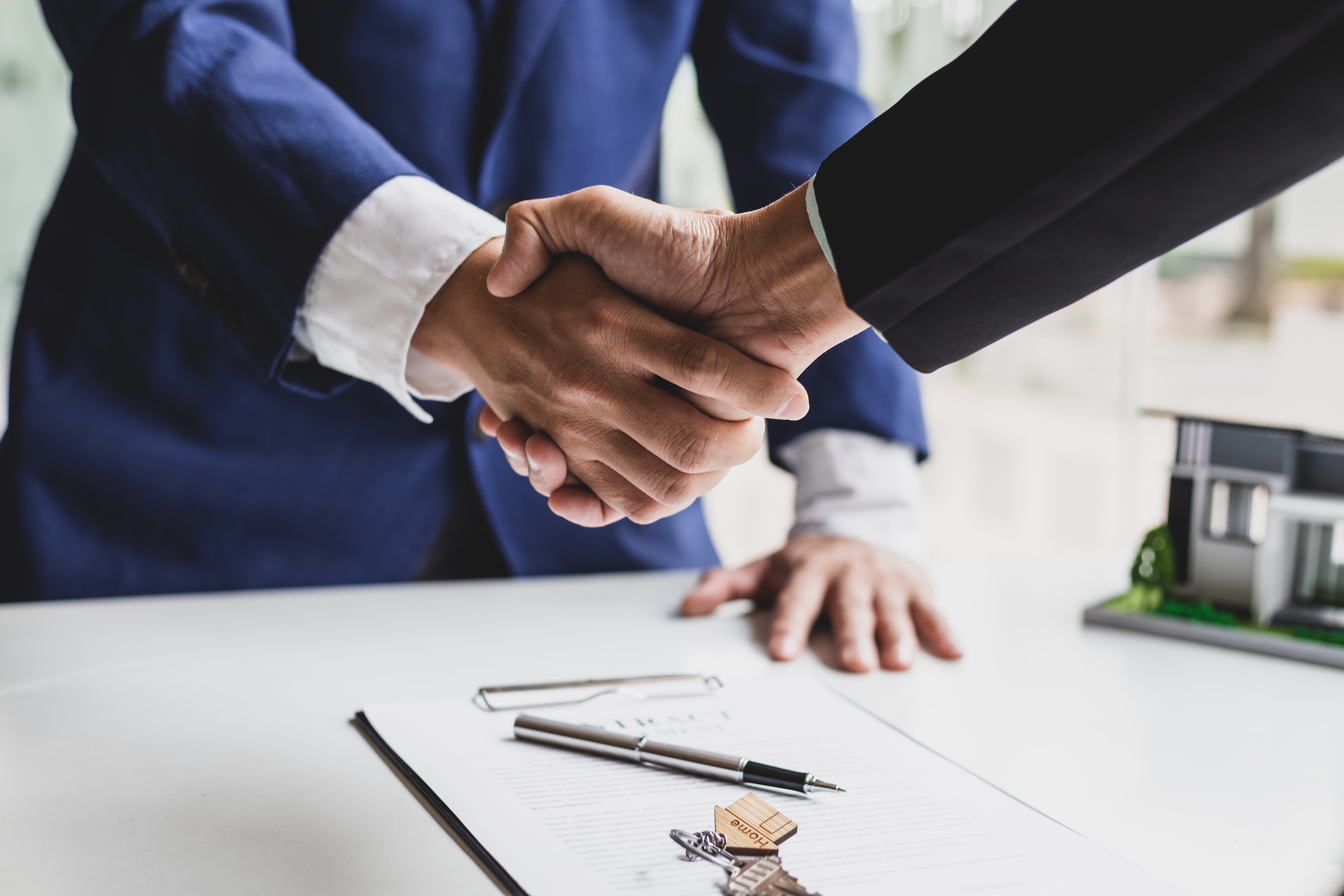 businessman and real estate agent shaking hands af 2026 01 09 00 54 44 utc